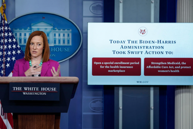Jen Psaki at white house podium in front of sign